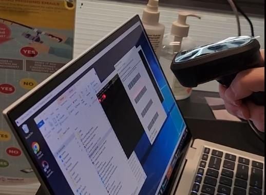A Grant Thornton Australia IT worker's hand scanning a barcode A Grant Thornton Australia IT worker's hand scanning a barcode